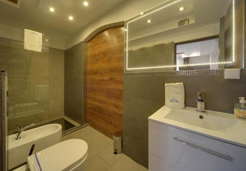 a bathroom with a sink and a toilet and a mirror at Apart Invest Dworcowa 1 i 2 in Szklarska Poręba