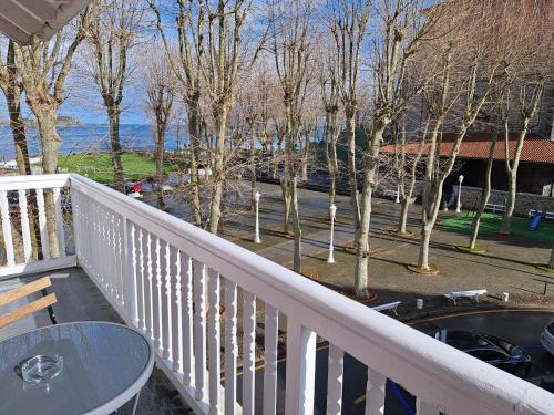 a balcony of a house with a table and trees at Hotel Atalaya- FREE PARKING GRATUITO in Mundaka