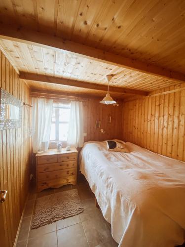 a bedroom with a large bed and a window at Hvammur Cottages in Godafoss