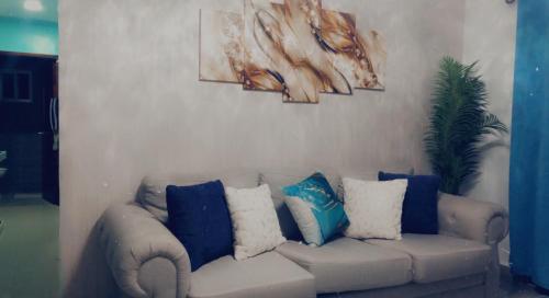 a living room with a couch with pillows on it at Residencial Santa Rosa Apto 8 Section C in Moca