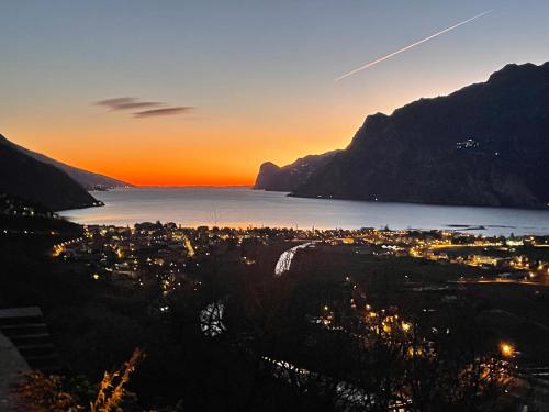 a view of a city at sunset with a mountain at Hotel Alfieri in Sirmione