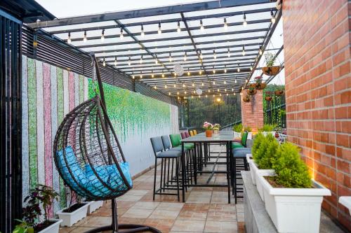 a patio with a hammock and a table and chairs at The Eleganza in Jhājra