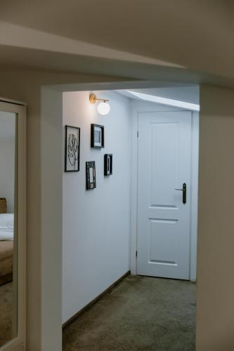 a white door in a room with a bed at La Fontaine in Hunedoara