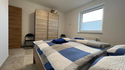 two beds in a bedroom with a window at Bella Vista - a76204 in Walchum