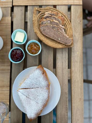a table with two slices of bread and some condiments at B&B San Gregorio SINNAI in San Gregorio