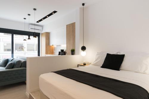 a bedroom with a large bed and a couch at Voda Luxury Residence #401 in Athens