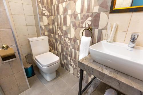 a bathroom with a toilet and a sink at Alaska Resort in Tsaghkadzor