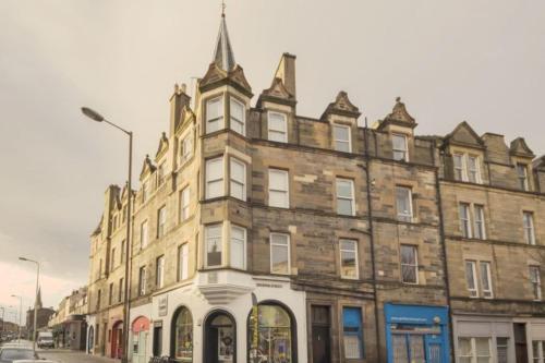 a large brick building on a city street at 1 Bed Apartment (sleeps 4) on Leith Walk in Edinburgh