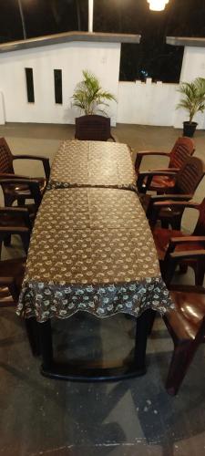 a large table in a room with chairs at White House Residency in Varkala