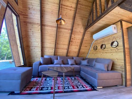 a living room with a couch and a table at Agora Farmhouse in Koman
