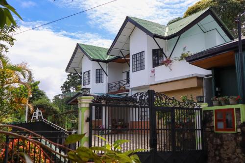 a house with a gate in front of it at Hill Crest Holiday Bungalow in Diyatalawa