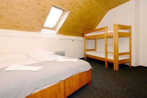a bedroom with two bunk beds and a window at Horská Chata Sabinka in Malá Morávka