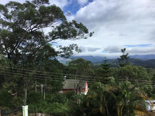 a view of a house with mountains in the background at Hill Crest Holiday Bungalow in Diyatalawa
