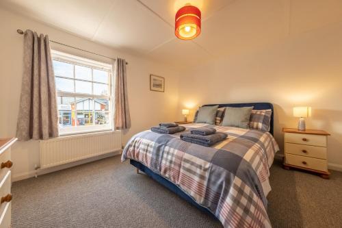a bedroom with a bed and a window at The Town House in Woodbridge