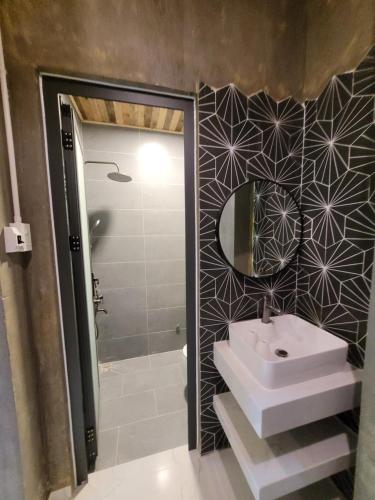 a bathroom with a sink and a shower at Lightning House in Da Lat