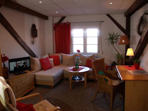 a living room with a couch and a table at Hermanns Hotel Zum Goldenen Stern in Jüterbog