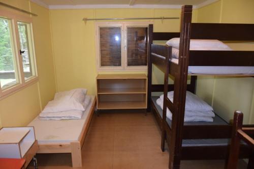 a room with two bunk beds and a window at Areál Ontario Kyselka in Kysibl Kyselka