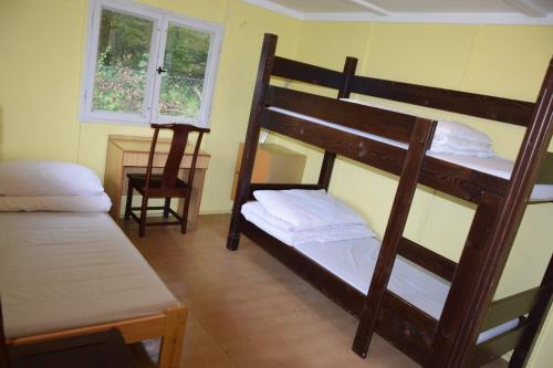 a bedroom with two bunk beds and a desk at Areál Ontario Kyselka in Kysibl Kyselka