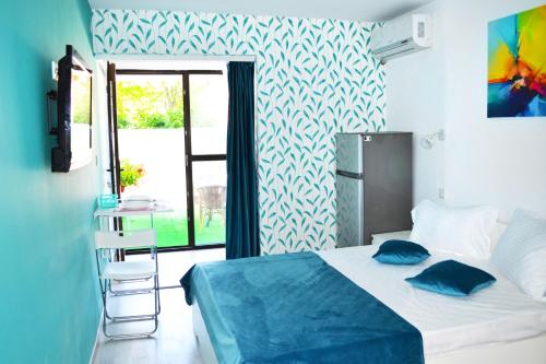 a bedroom with a bed with blue pillows on it at LUCA Apartments in Saturn