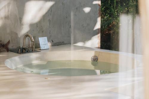 a glass table with a sink and a mirror at Proud Phu Fah Maerim Resort in Mae Rim