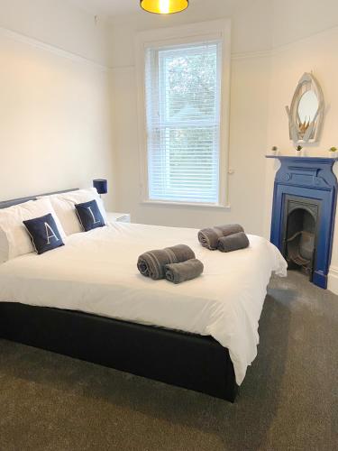 a bedroom with a large bed with two towels on it at Sail Away Coastal Apartment Near Beach Parking Included Pet Friendly in Bournemouth