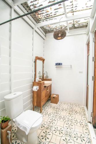 a bathroom with a toilet and a sink at Proud Phu Fah Maerim Resort in Mae Rim