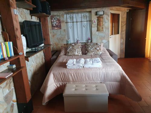 a bedroom with a large bed with towels on it at La Dependance delle Mimose in Isola delle Femmine