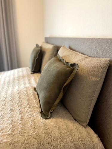 a group of pillows sitting on top of a bed at Apartmán FREYA in Liptovský Mikuláš