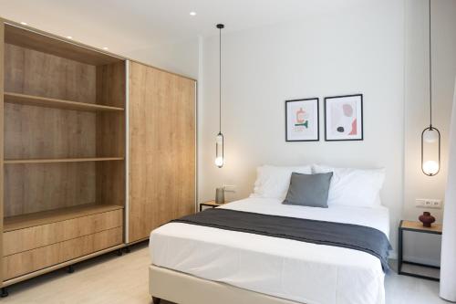 a bedroom with a large bed and wooden cabinets at Voda Luxury Residence #402 in Athens