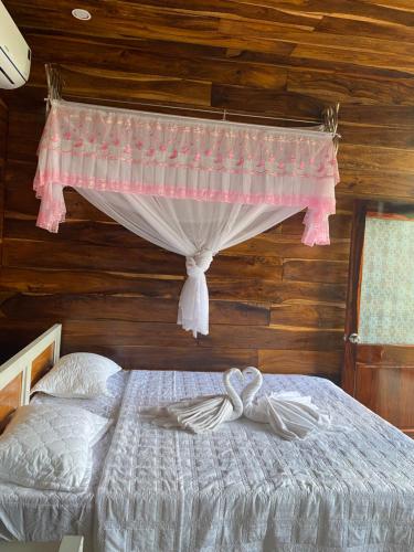 a bedroom with a bed with a canopy at FOREST BREATH ECO-LODGE in Tân Phú
