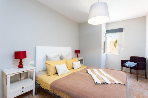1 dormitorio con 1 cama grande con almohadas amarillas en Villa lussuosa a 1,5 chilometri da Costa Adeje en Adeje