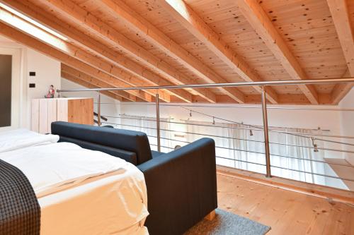 a bedroom with two beds and a balcony at Relax in Pineta in Caldonazzo
