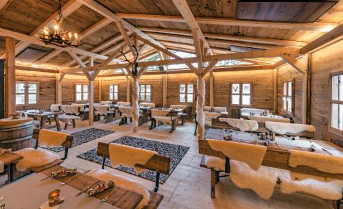 a large room with tables and chairs and windows at Landgasthof Hirschen in Hohenems