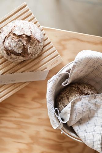 two loaves of bread sitting on a cutting board at MÜHLENHOF ROOMS boutique bed & breakfast in Langenlois