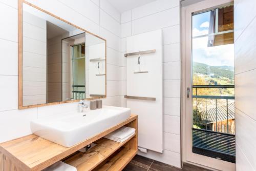 a bathroom with a sink and a window at Eberharthof in Saalbach-Hinterglemm