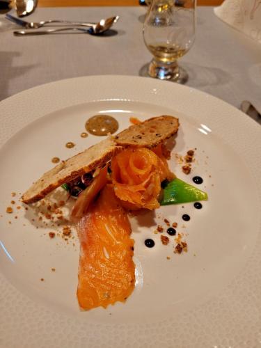 a white plate with food on a table at Landgasthof Hirschen in Hohenems