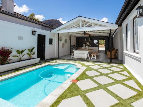 a swimming pool in the backyard of a house at The Belmont in Franschhoek