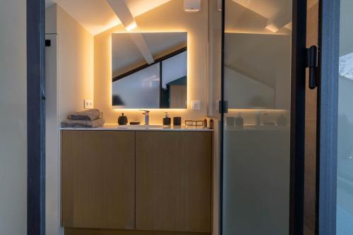 a bathroom with a sink and a mirror at Mougins Collection - Magnifique maison au Cœur du Vieux Village de Mougins, vue sur les Alpes du Sud in Mougins