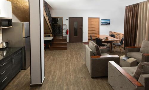 a living room with a couch and a dining room at Alaska Resort in Tsaghkadzor