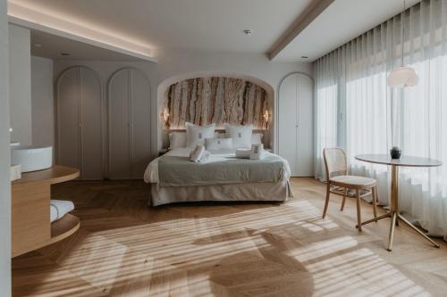 Postel nebo postele na pokoji v ubytování Hotel Petit Luxe