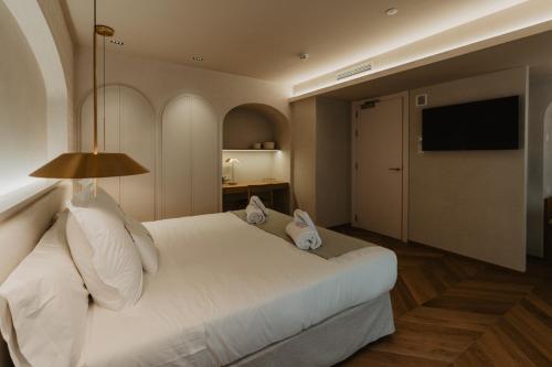 Postel nebo postele na pokoji v ubytování Hotel Petit Luxe