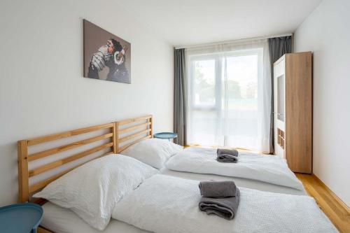 En eller flere senge i et værelse på Donaufeld Living - Modernes und helles Apartment