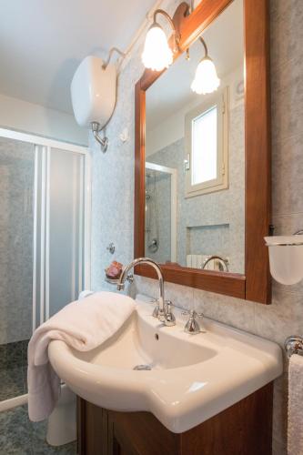 a bathroom with a sink and a mirror at B&B Corte Dei Musco in Lecce
