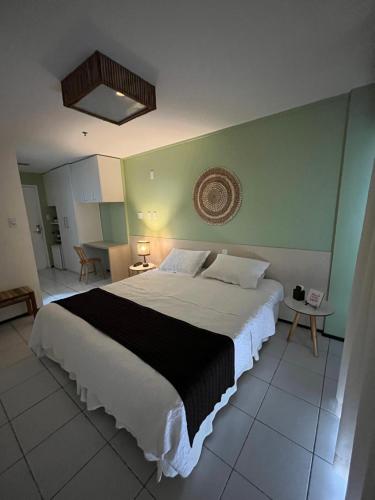 a bedroom with a large bed with a black and white blanket at Gran Lençóis Flat Apartamento in Barreirinhas