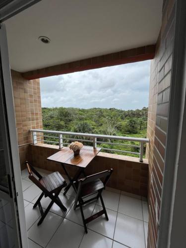 a table and chairs on a balcony with a view at Gran Lençóis Flat Apartamento in Barreirinhas