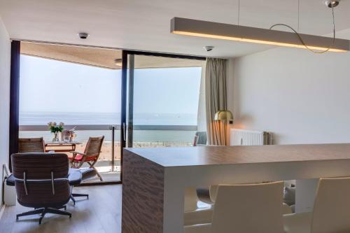 a kitchen and dining room with a view of the ocean at Luxury Suite with Seaview in Ostend