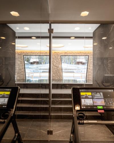 a lobby with a glass door and a staircase at Campiglio WOOD in Madonna di Campiglio