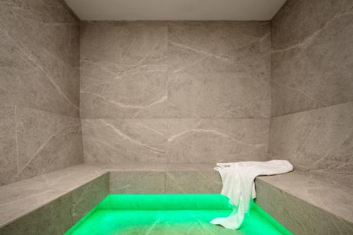 a bathroom with a bath tub with a white towel at Campiglio WOOD in Madonna di Campiglio