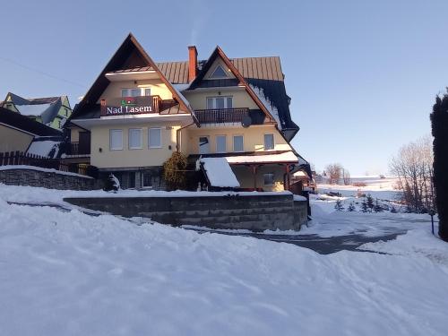 a large house with snow on the ground at Nad Lasem in Bukowina Tatrzańska