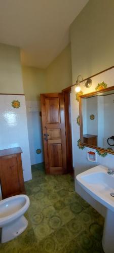 a bathroom with a sink and a toilet and a mirror at Poggio alla Scaglia in Florence